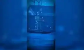 A clear glass with blue liquid, showcasing XYUltra supplement bottle in the background, emphasizing hydration, wellness, and premium health products.