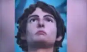 A young woman with short, dark curly hair looking confidently forward, emphasizing empowerment and strength.